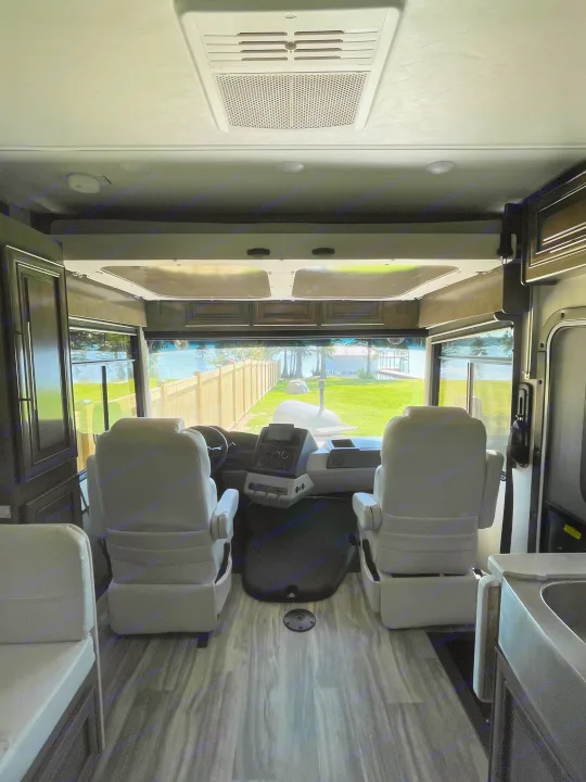 Explore this RV rental's inviting interior. Featuring cockpit, comfy seats, and a stunning waterfront view from the front.. Georgetown GT7 2022