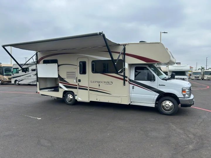 Spacious Class C RV rental with extended awning and open storage, parked and ready for adventure.. Coachmen Leprechaun 2020