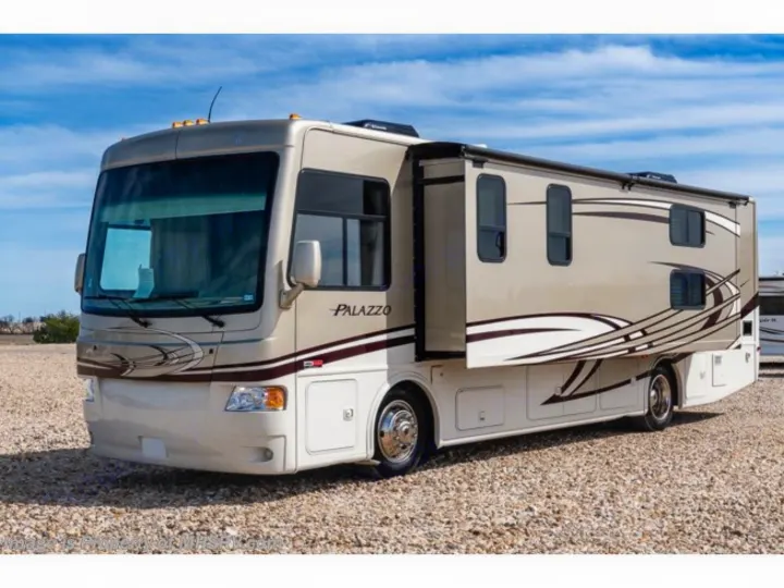 A large, tan motorhome with a side slide-out extended, perfect for rv rental. Explore in comfort with this recreational vehicle.. Thor Palazzo 2013
