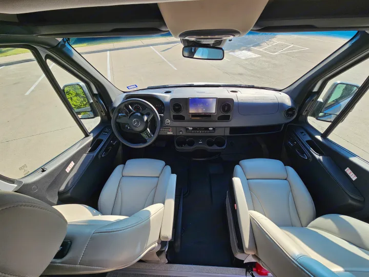 Spacious RV rental cockpit with cream leather seats and a modern dashboard, perfect for your next road trip.. Grech Strada Ion 2022
