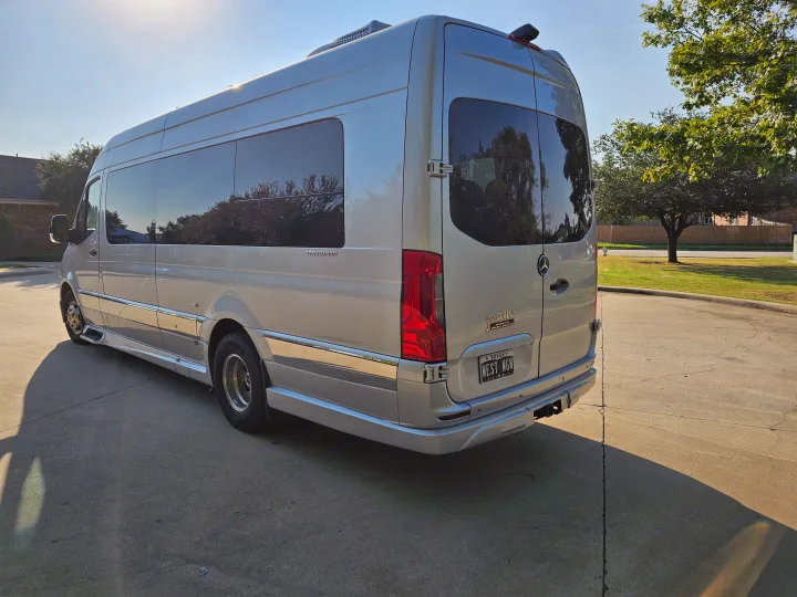 Silver Mercedes-Benz Sprinter RV rental with 'WEST WGN' plate, parked on a sunny paved drive.. Grech Strada Ion 2022
