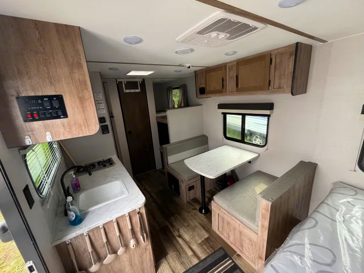Inside a modern RV rental featuring a full kitchen, dinette, and sleeping accommodations.. Gulf Stream grand river 2024