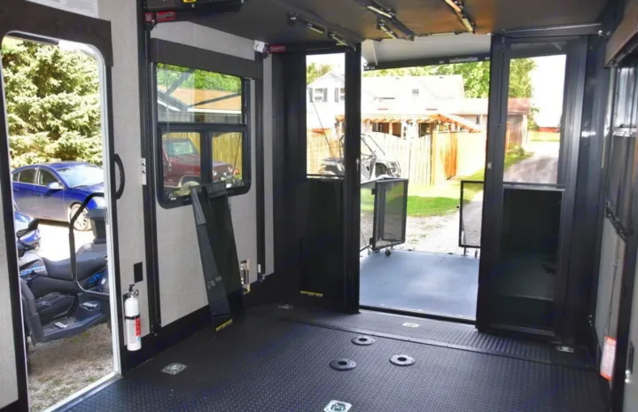 Spacious rv rental toy hauler interior: durable floor, tie-downs, and open ramp.. Jayco Seismic 2023