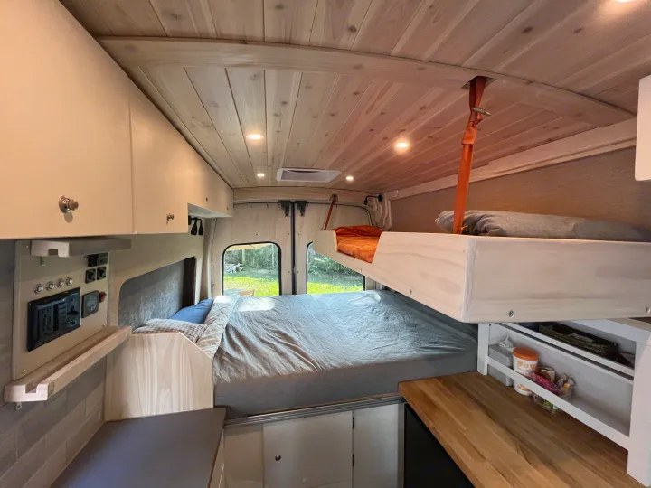 RV rental: View inside a custom camper van with bunk bed, main bed, and practical control panel. Ready for adventures!. Custom Built Transit 2017