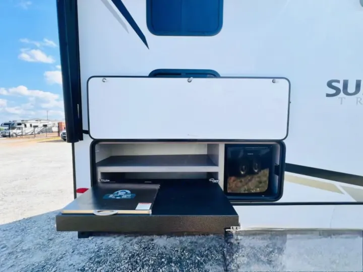 Convenient outdoor kitchen in an RV rental, with pull-out grill, fridge, & storage. Perfect for camping!. Crossroads Sunset Trail Super Lite 2022