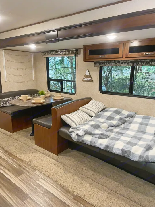 An inviting rv rental interior with a furnished dining booth and a cozy sofa bed ready for relaxation.. Jayco Jay Flight SLX 2017