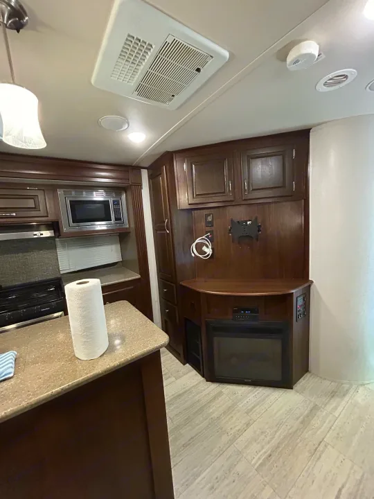 Step into this bright RV rental with a fully equipped kitchen, entertainment area with fireplace, and AC unit overhead.. Palomino Solaire 2018