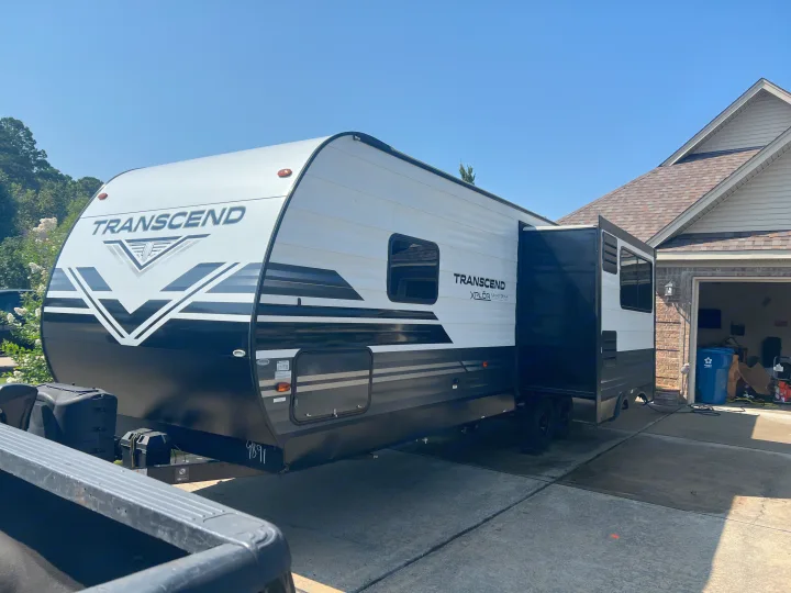 Grand Design Transcend RV rental parked in a sunny driveway with its slide-out extended, ready for adventure.. Grand Design Transcend 2021