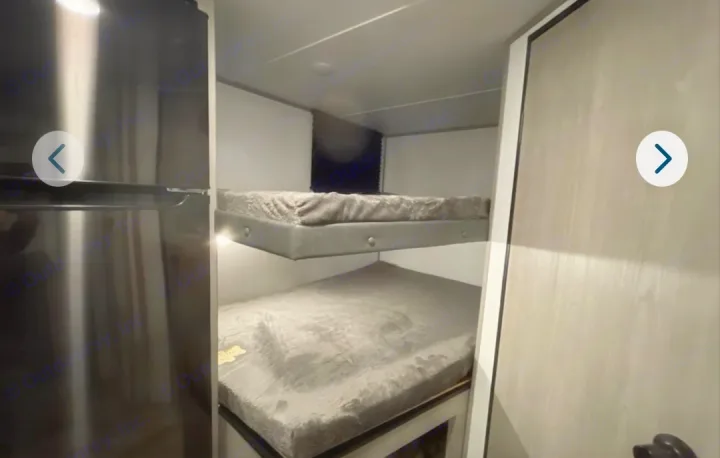 RV rental: Bunk beds with mattresses and a dark refrigerator maximize sleeping space in this compact RV.. Dutchmen Coleman Lantern Lt 19BB 2024