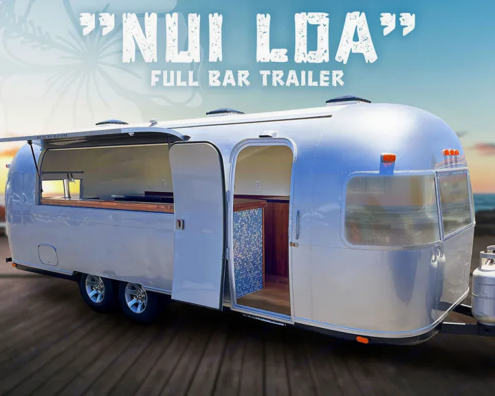 This full bar Airstream-style trailer is open for rv rental, showing taps, wooden counters, and a tiled interior.. Airstream custom 1973