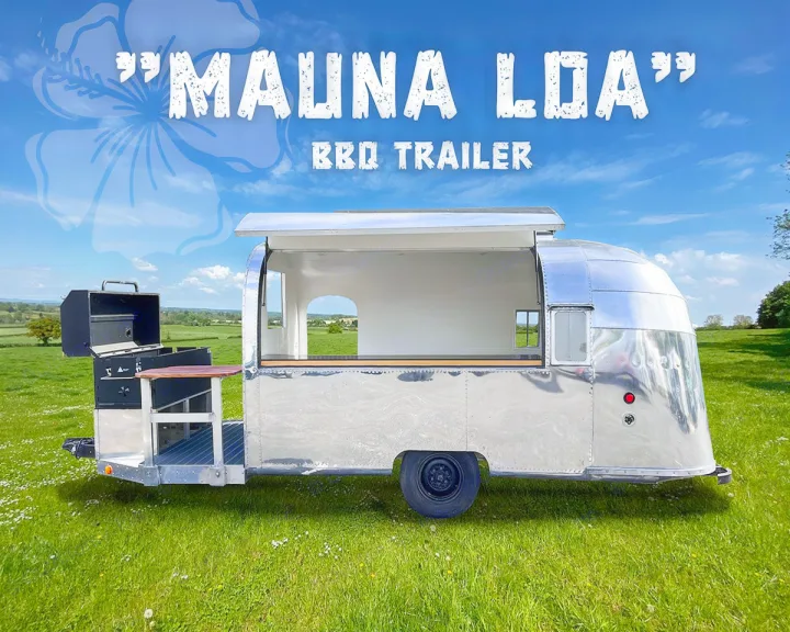 "Mauna Loa" BBQ Trailer: Shiny, vintage-style mobile food unit with grill in a green field. Perfect as a unique RV rental.. Airstream Custom 1957