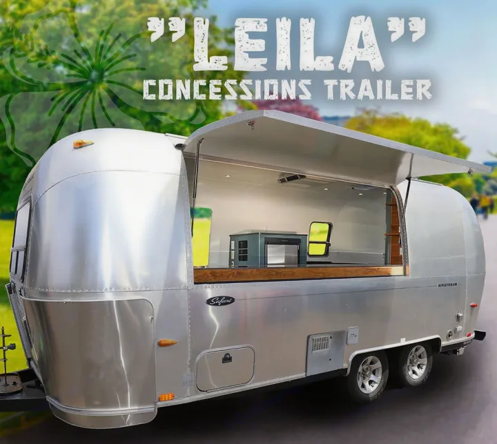 A sleek silver Airstream Safari concession trailer with its side open, showing a counter-filled interior. Great for an RV rental.. Airstream Custom 2006