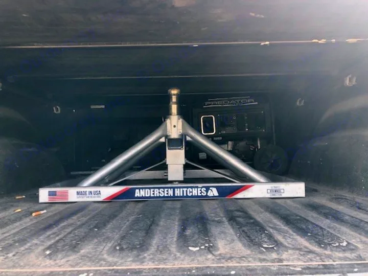 A truck bed holds an Andersen 5th wheel hitch and Predator generator, essential for an RV rental. Ready for a trip.. Astoria 1500 2021