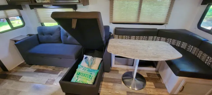 Inside this RV rental: a convertible sofa for extra sleeping & storage, plus a U-shaped dinette. Perfect for compact travel.. Coachmen Apex 265rbss 2019