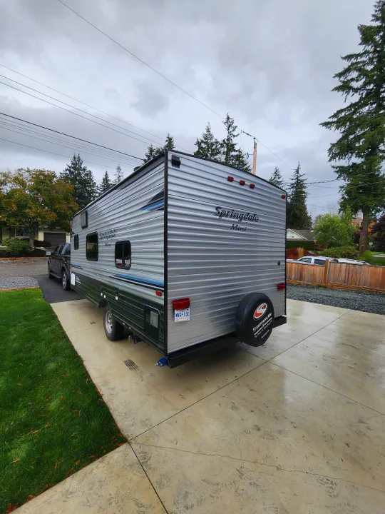 Springdale Mini travel trailer (Fraserway RV) for rv rental on a wet driveway.. Keystone RV Springdale 2018