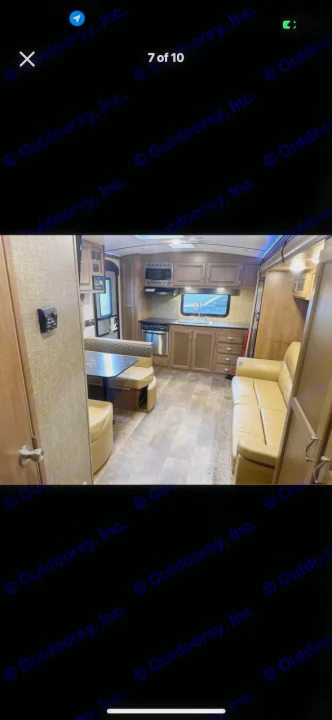 Spacious RV rental interior featuring a kitchen, dinette with bench seating, and light-colored sofa, all on wood-look flooring.. KZ Spree 2017