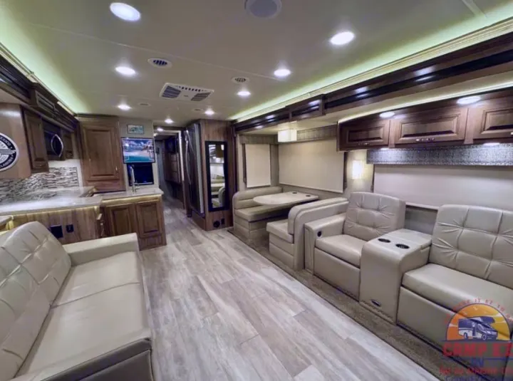 This spacious RV rental interior features a modern kitchen, dinette, and comfortable sofa & recliners for your road trips.. Jayco Seneca 2020