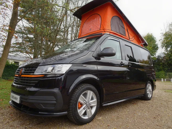 Black VW Transporter campervan with orange accents & pop-top, great for your next rv rental adventure.. Volkswagen T6.1 2020