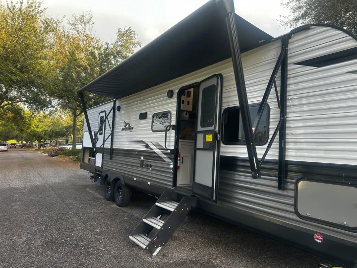 Jayco Jay Flight RV rental: a grey travel trailer with an extended awning and steps down, ready for your adventure.. Jayco Jay Flight 2024