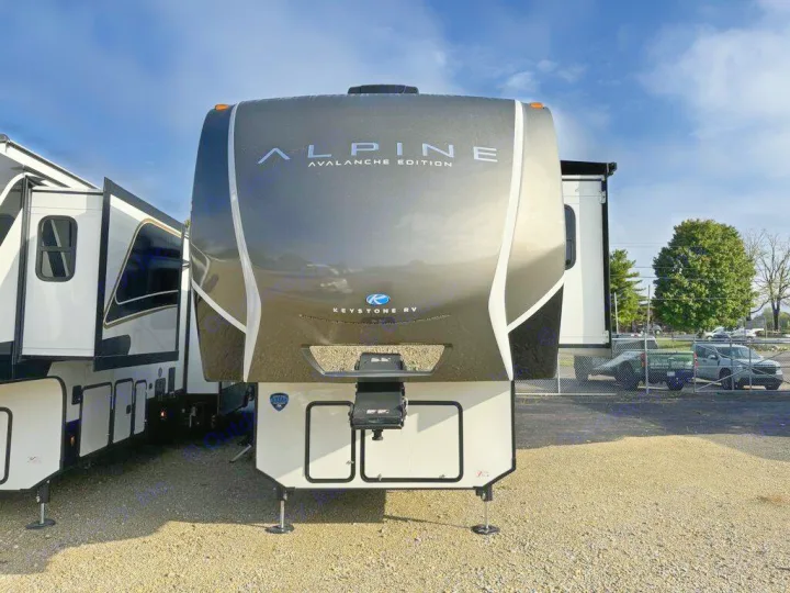 A sleek dark gray and white Keystone Alpine Avalanche Edition fifth-wheel RV, ready for your next RV rental journey.. Keystone Alpine 2025