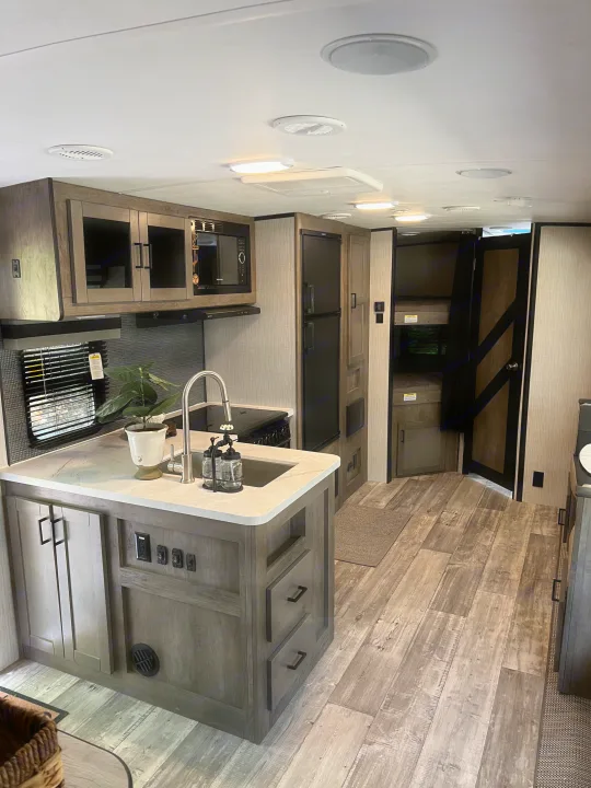 Step inside this modern RV rental: a fully-equipped kitchen island, appliances, and cozy bunk beds await.. Heartland RVs North Trail 2021