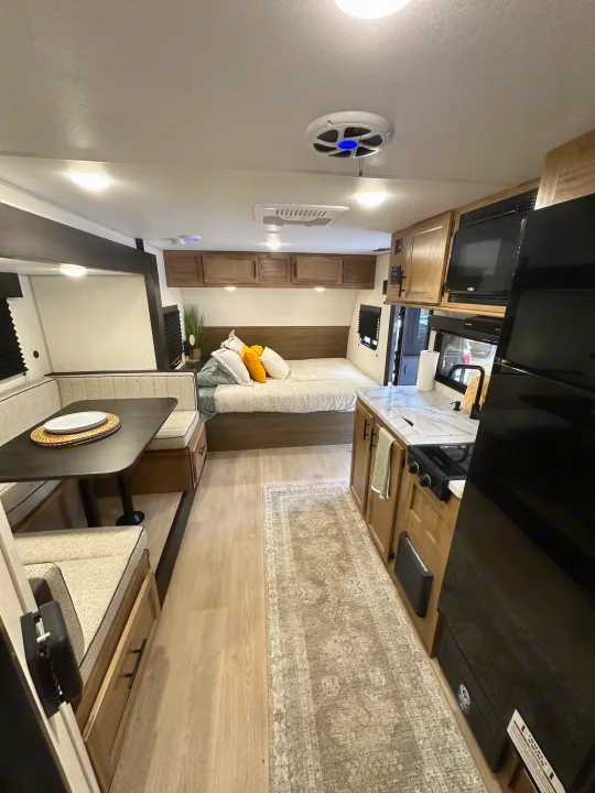 RV rental: Bright interior featuring a practical dinette, cozy sleeping area, and compact kitchen.. Cherokee Wolf pup 2025