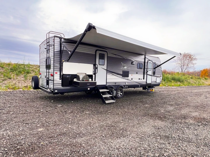 This Jay Flight RV rental features an extended awning & outdoor kitchen, perfect for your next adventure parked on a gravel lot.. Jayco Jayflight 2021