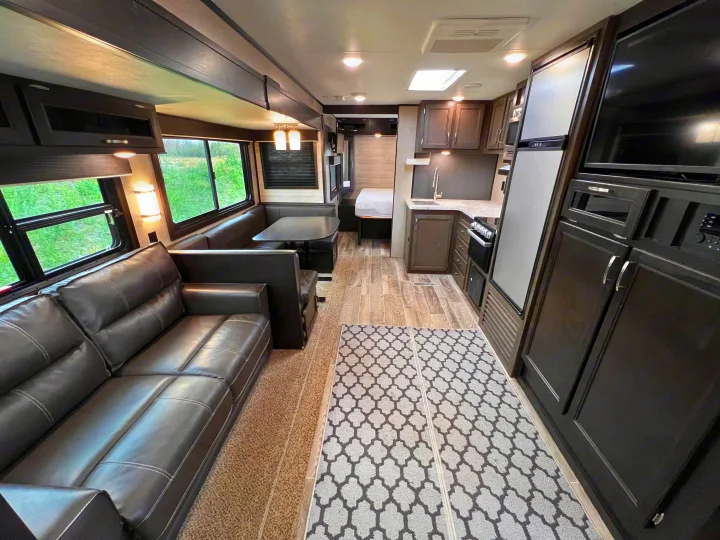 RV rental: Bright, spacious interior featuring a living area with couch, dinette, full kitchen, and rear bedroom.. Jayco Jayflight 2021