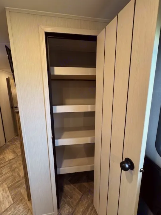 RV rental: Open pantry with light-colored shelves offers ample storage inside this bright interior.. Palomino Puma 2023