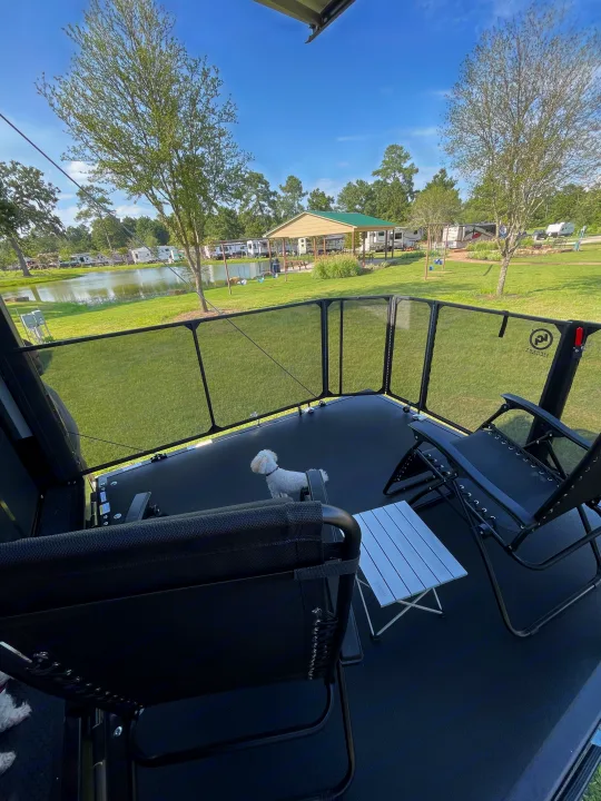 This RV rental offers a spacious patio, perfect for relaxing with your dog. Enjoy the scenic lake & campground view.. Grand Design Momentum 2024