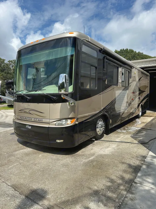 Sleek Kountry Star RV rental, a beige & black luxury motorhome, gleaming after a wash. Ready for your next travel adventure!. Kountry Star Kountry Star Motorhome 2008