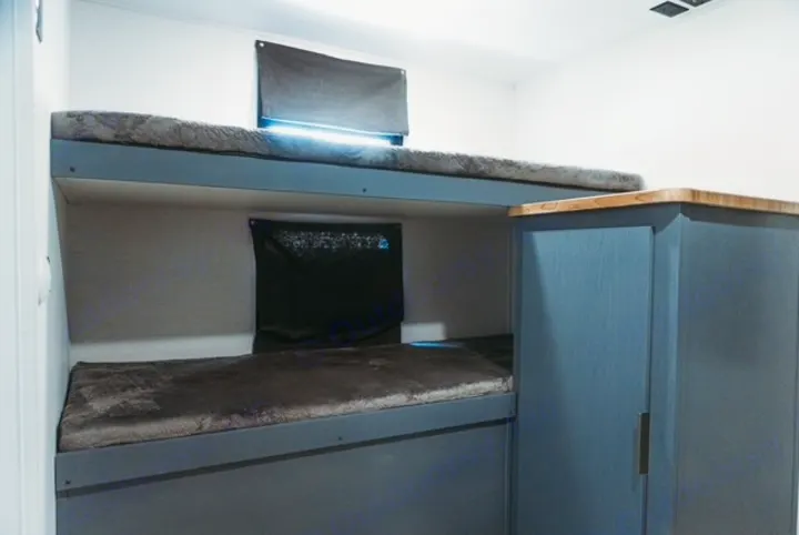 This RV rental offers cozy bunk beds, with soft bedding, window shades, and built-in lighting.. Forest River Tracer 2024
