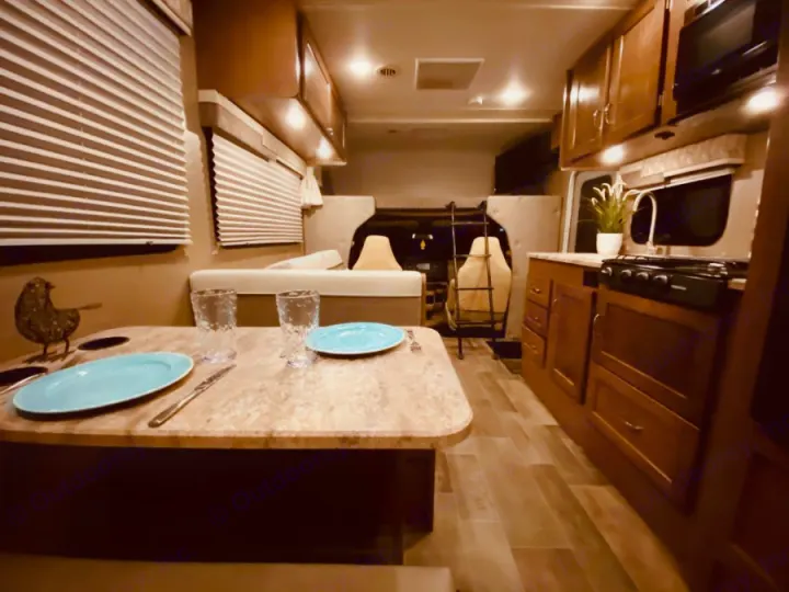 Experience comfort in this RV rental! Features a dining area, fully-equipped kitchen, and rear bunk beds, all brightly lit.. Winnebago 25 2019