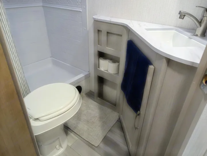 Clean and compact RV rental bathroom: white toilet, shower area, and modern vanity with sink.. Cruiser Rv Corp Other 2024