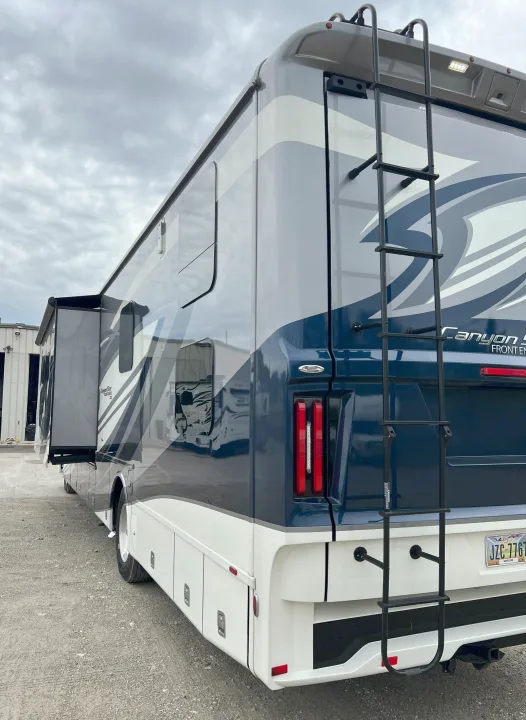 This large blue & white Class A motorhome, with an extended slide-out & rear ladder, is ideal for your RV rental adventure.. Newmar Canyon Star 2021