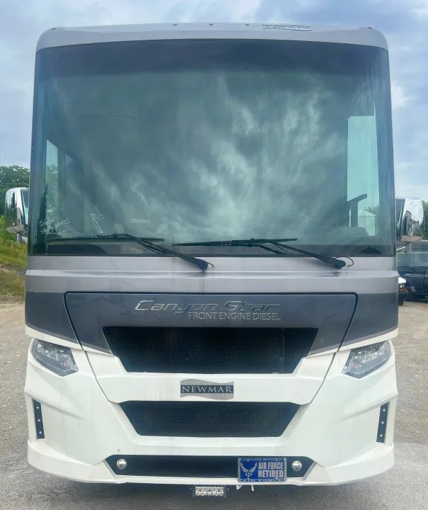 Front view of a white & gray Newmar Canyon Star Front Engine Diesel RV, perfect for your next rv rental adventure.. Newmar Canyon Star 2021