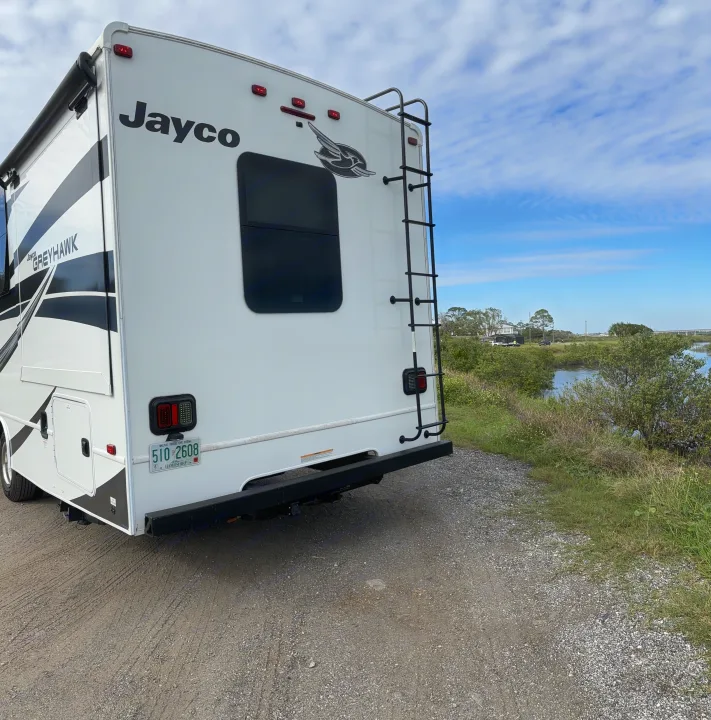 Jayco Greyhawk RV rental parked by a scenic marsh, ready for nature adventures. Live Free or Die!. Jayco Greyhawk 2022