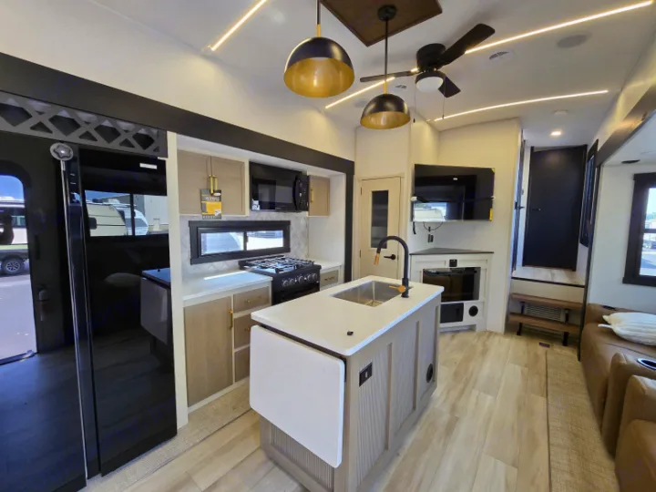 Spacious RV rental interior featuring a modern kitchen island, full appliances, and comfortable living area.. Forest River Hemisphere 2025