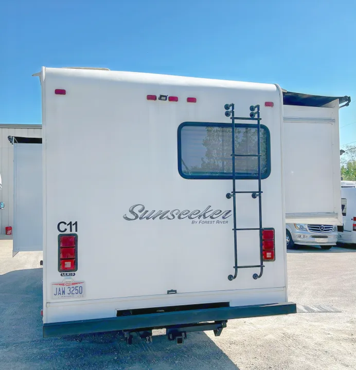 Back of a white Sunseeker rv rental by Forest River, featuring its ladder and Ohio license plate.. Forest River Sunseeker 2016