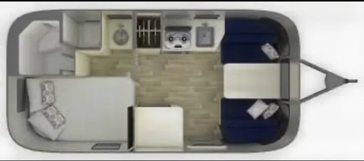 RV rental floor plan: Top-down view of an RV's interior with a bedroom, kitchen, bathroom, and front dining/lounge area.. Airstream Airstream 2020