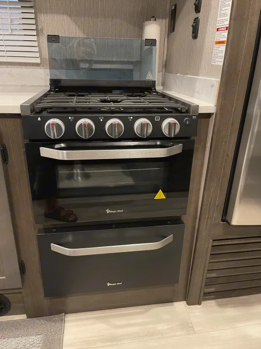 Explore the well-equipped kitchen in your RV rental! Featuring a Magic Chef gas stove, oven, and storage space.. Forest River Coachmen Leprechaun Premier 2022