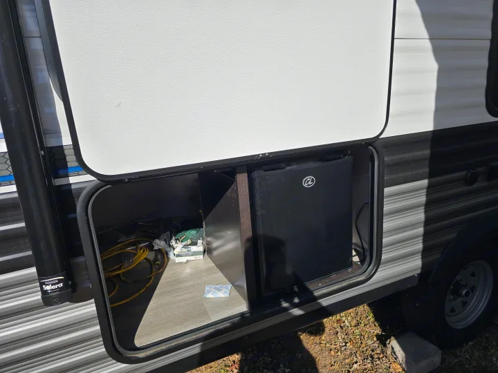 This RV rental offers convenient outdoor access to a mini-fridge and utility storage in its side compartment.. Jayco Jay Flight SLX 2022