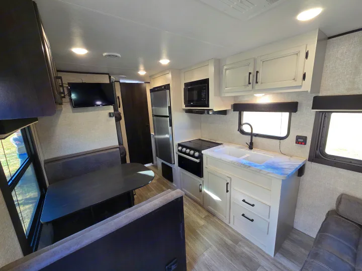 Modern RV rental interior with a fully equipped kitchen, comfortable dinette, and lounge area. Ready for your next adventure.. Jayco Jay Flight SLX 2022