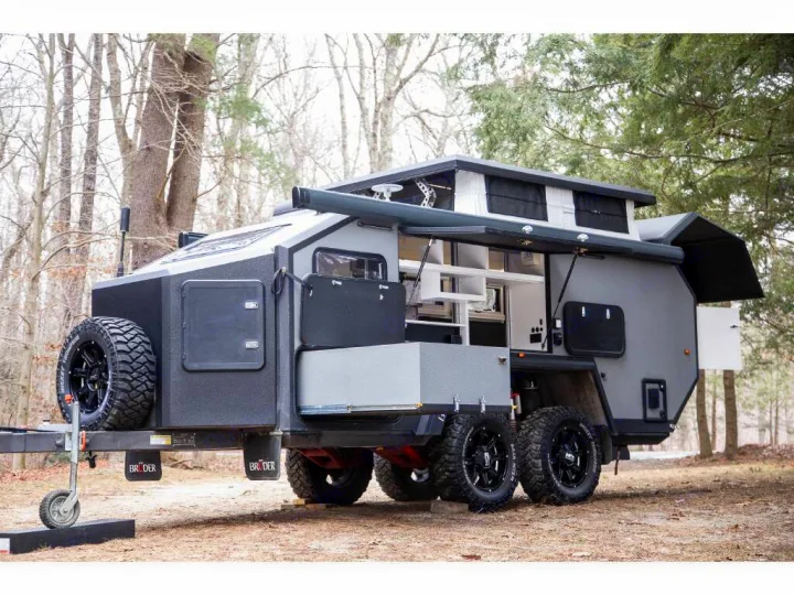Rugged grey off-road travel trailer showcasing its outdoor kitchen and pop-top. Perfect for your RV rental adventure.. Bruder EXP-6 2018