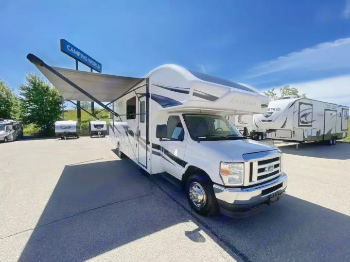White Entegra Class C RV with extended awning, parked at a dealer. Perfect for your next rv rental adventure.. Entegra Coach Odyssey 2024