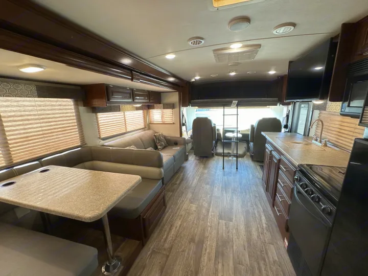 Experience comfort in this rv rental. Features a full kitchen, dining booth, sofa, and wood-look flooring throughout.. Forest River Fr3 2019