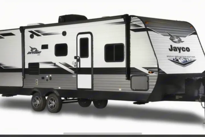 White and black Jayco travel trailer, a spacious RV rental option for camping and outdoor trips.. Jayco Jay Flight 2022