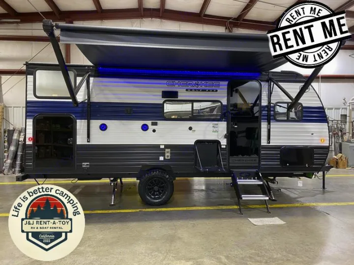 Rent this blue & white Cherokee Wolf Pup travel trailer! Spacious RV rental with an extended awning & blue LEDs. Ready for adventure.. Forest River 17JW 2025