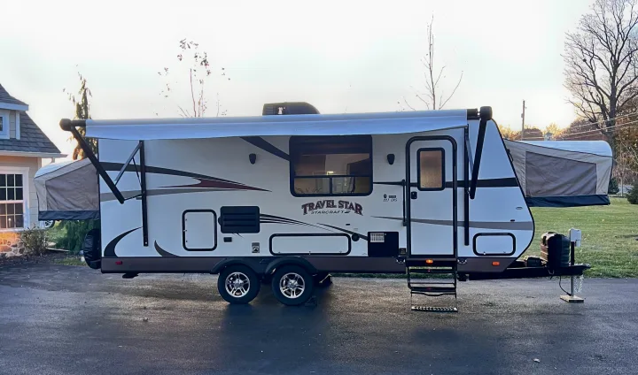 This Travel Star 227 CKS travel trailer, an RV rental with awning extended, is parked & ready for your next adventure.. Starcraft Travel Star 2015