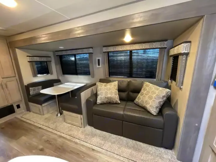 Spacious RV rental interior featuring a comfortable dinette and a pull-out sofa, ideal for travel living.. Coachmen Catalina 2022